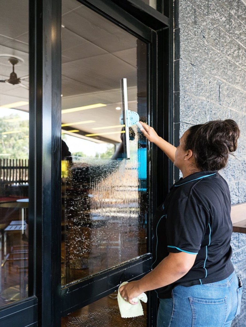 Female cleaner, cleaning windows